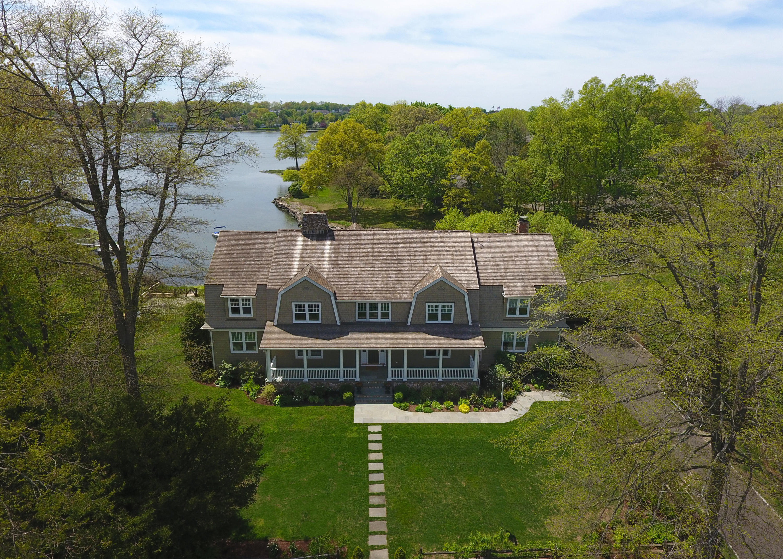 15 Seagate Road Darien, CT 06820 - Photo 1 of 48 a view of a house with a big yard and large trees