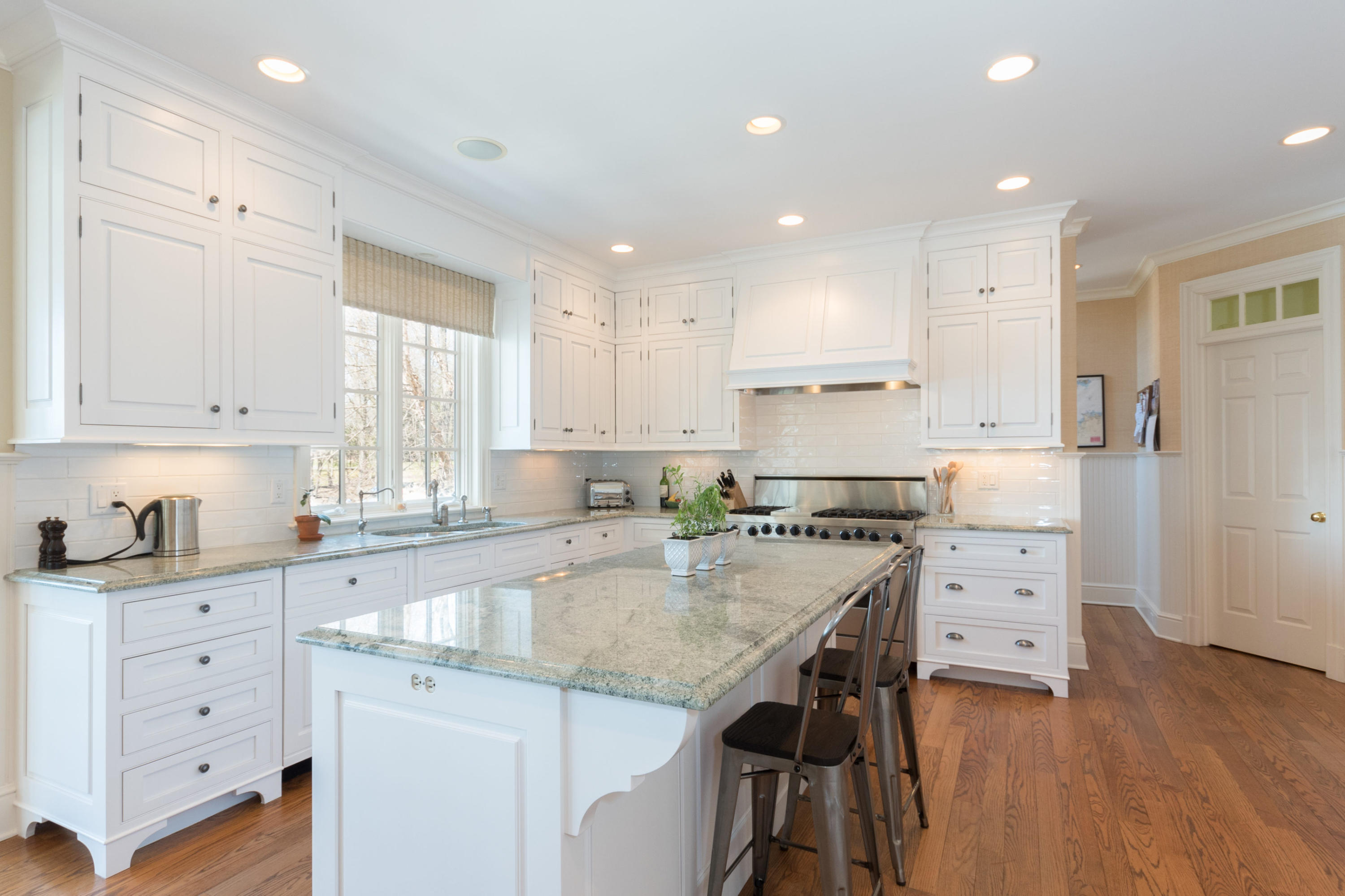 15 Seagate Road Darien, CT 06820 - Photo 18 of 48 a kitchen with a stove a sink and white cabinets