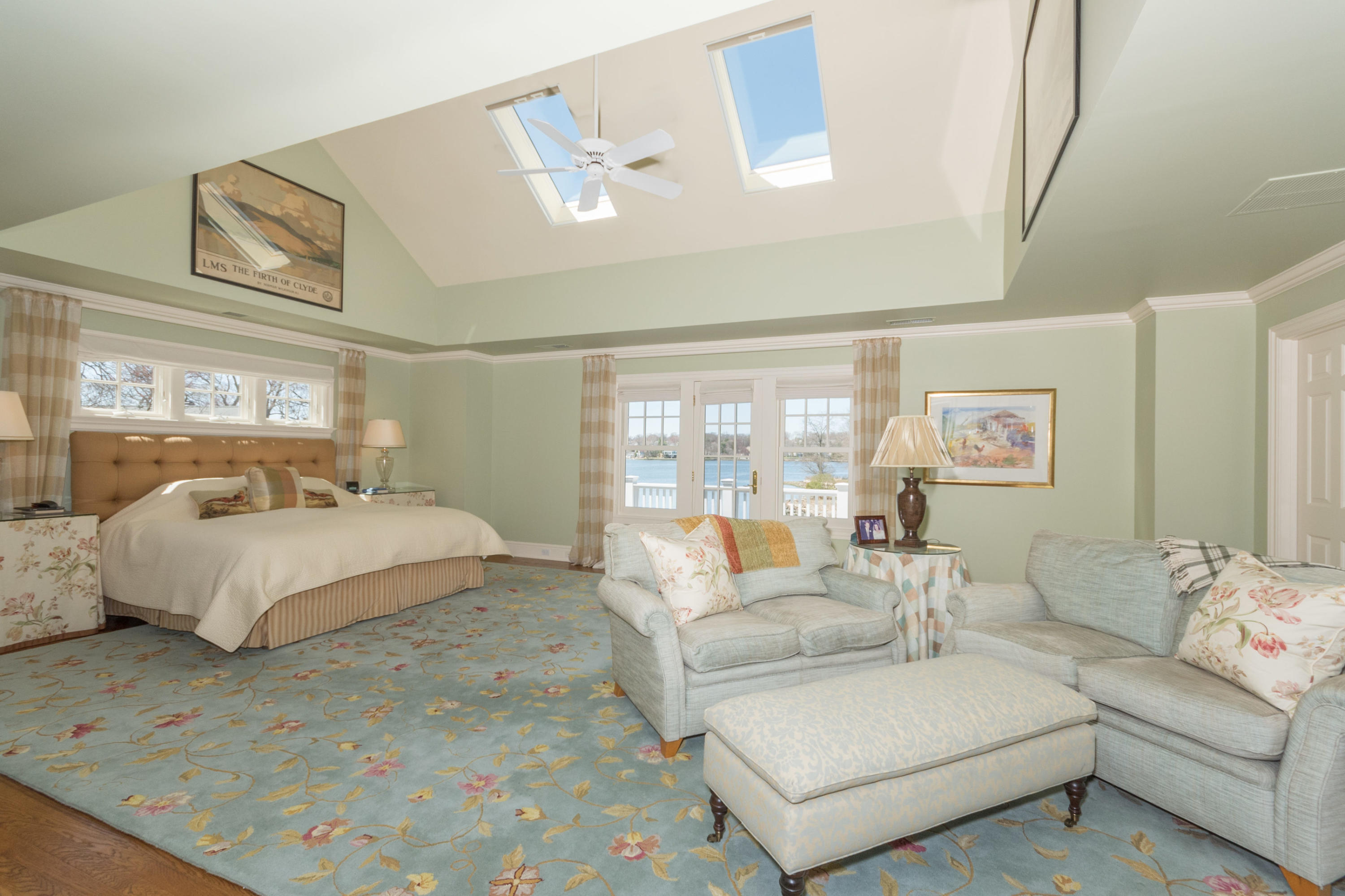 15 Seagate Road Darien, CT 06820 - Photo 25 of 48 a spacious bedroom with a bed a couch and large window