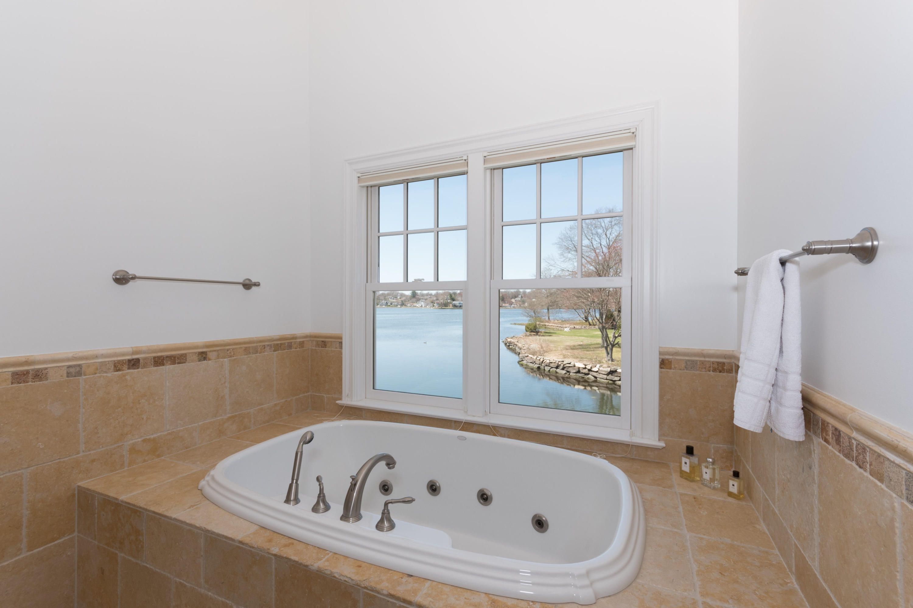 15 Seagate Road Darien, CT 06820 - Photo 28 of 48 a white bath tub sitting in a bathroom next to a window