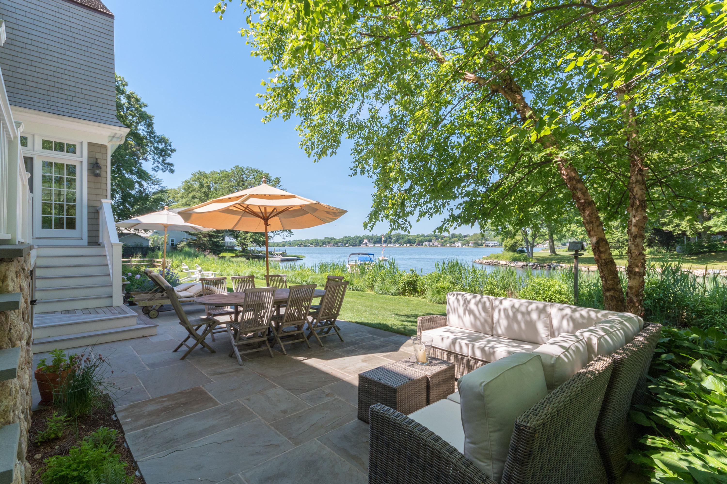 15 Seagate Road Darien, CT 06820 - Photo 42 of 48 a backyard of a house with yard table and chairs