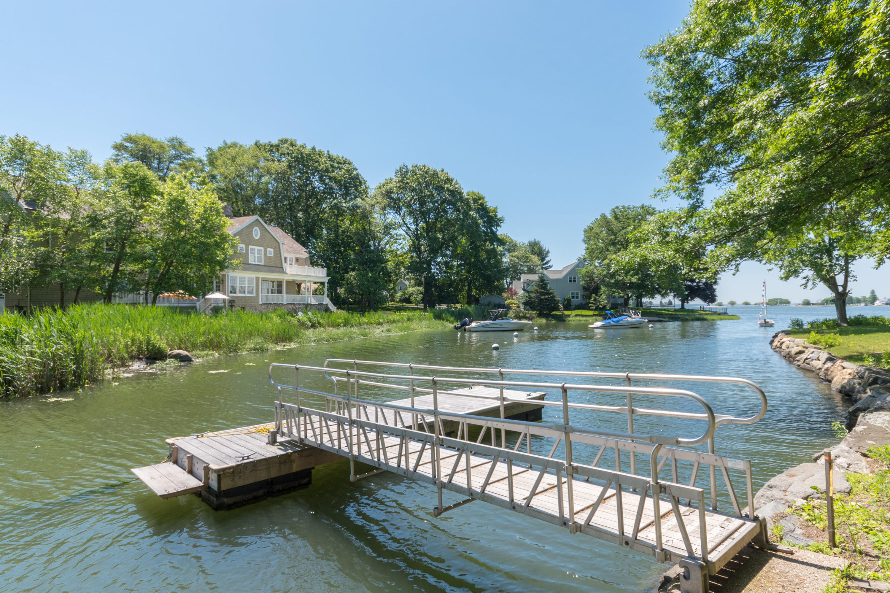 15 Seagate Road Darien, CT 06820 - Photo 45 of 48 a view of a lake with couches and wooden floor