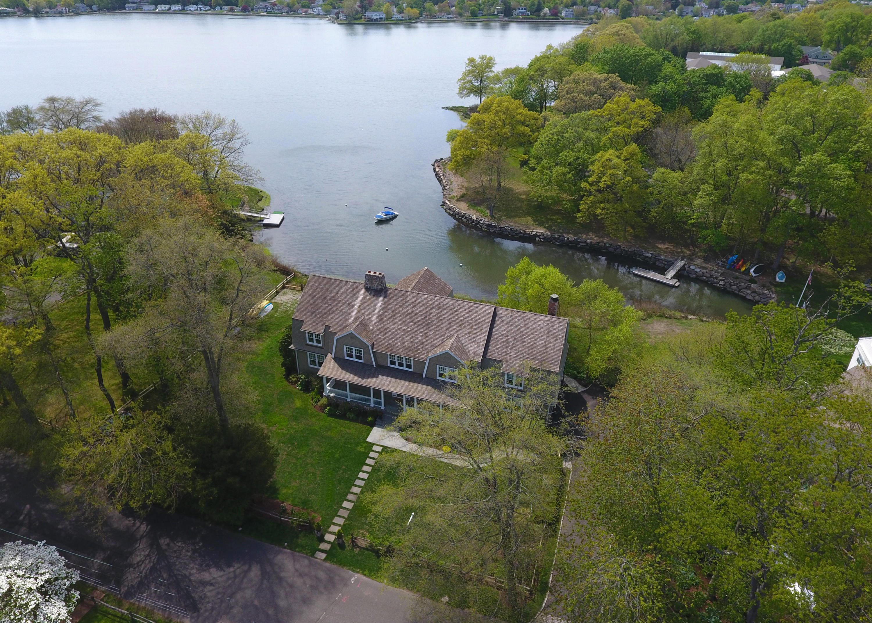 15 Seagate Road Darien, CT 06820 - Photo 6 of 48 a backyard of a house with lots of green space and lake view