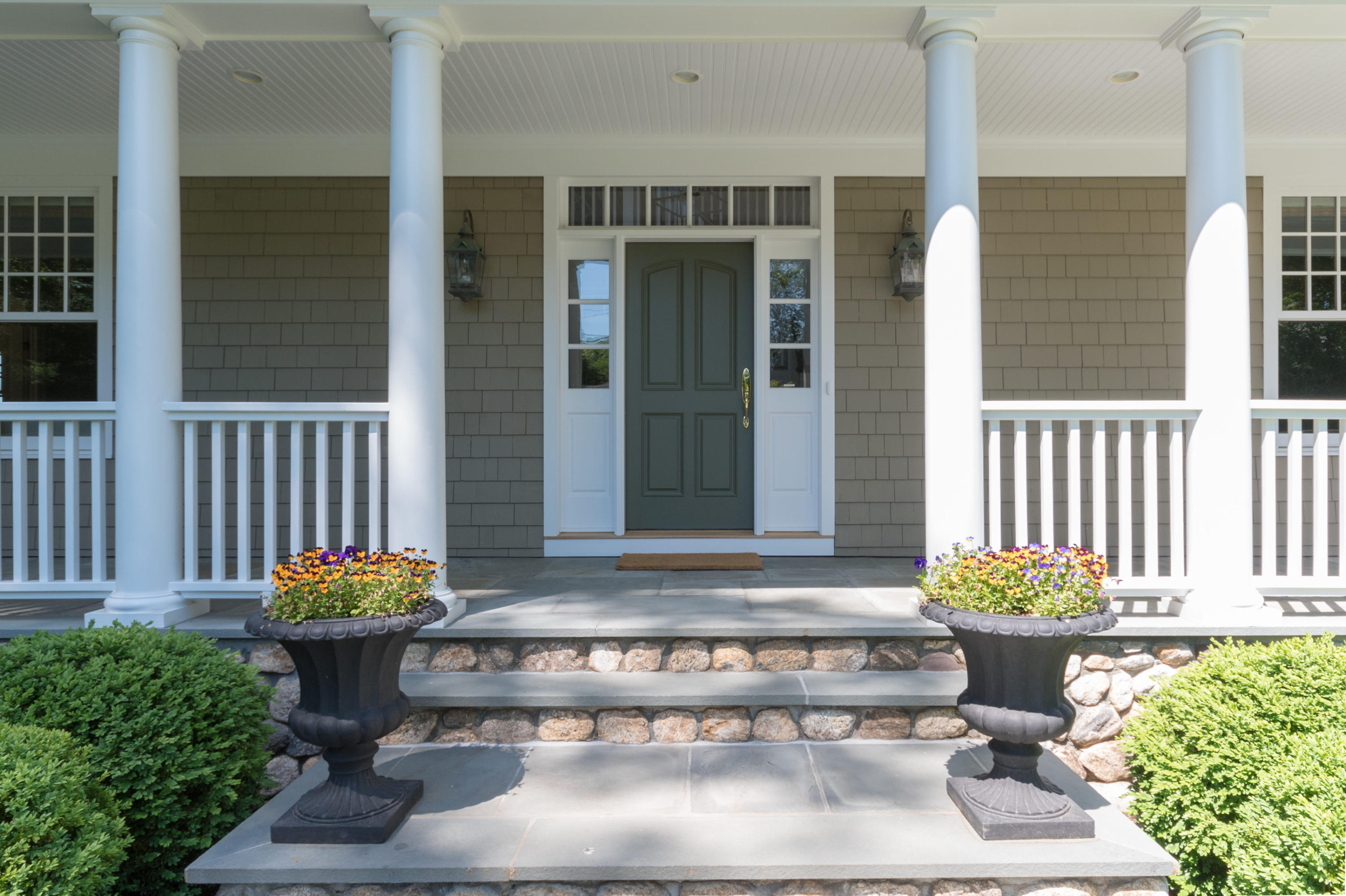 15 Seagate Road Darien, CT 06820 - Photo 8 of 48 a front view of a house with a large window and a potted plant