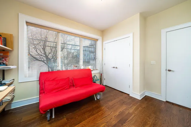 a living room with furniture and a floor to ceiling window