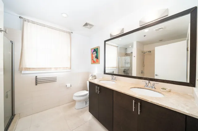 a bathroom with a sink a toilet and a mirror