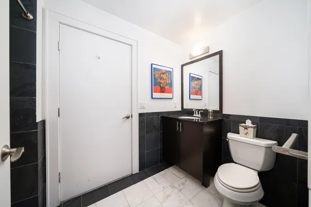 a bathroom with a toilet and a shower curtain