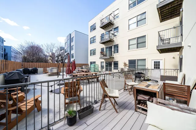 a view of a balcony with chairs and wooden floor