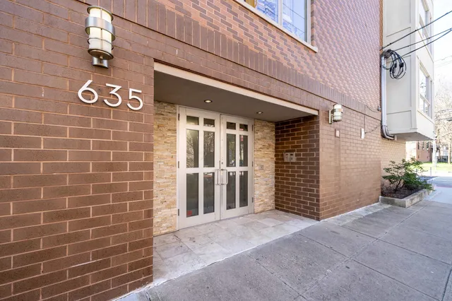 a view of a blue house with a street