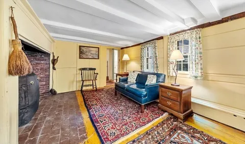 a living room with furniture rug and a fireplace