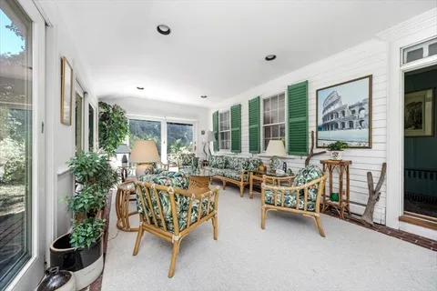 a balcony with furniture and potted plants