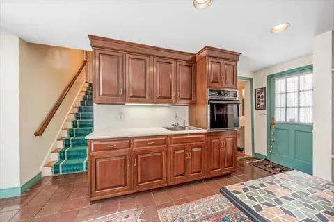 a kitchen with stainless steel appliances granite countertop a refrigerator and a stove top oven