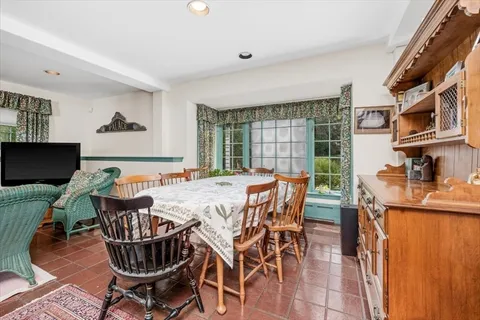 a view of a dining room with furniture window and outside view