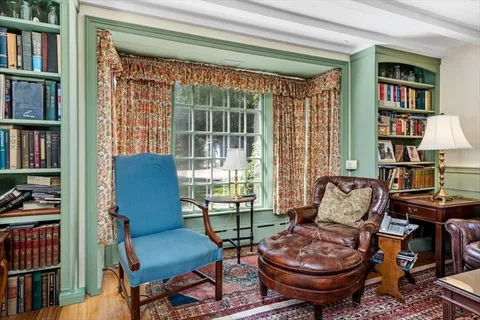 a living room with furniture and a book shelf