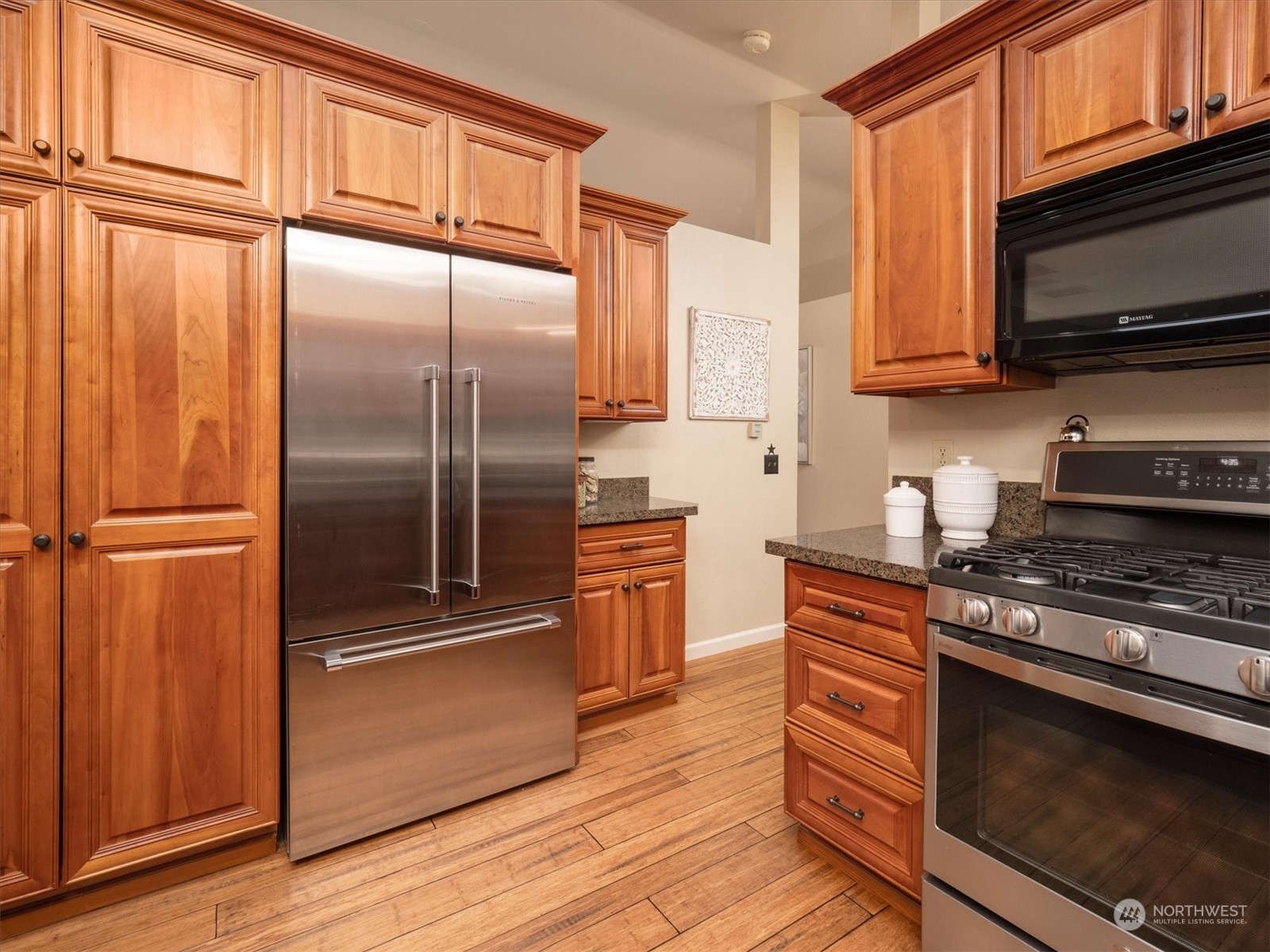 1622 243rd Place Southeast Bothell, WA 98021 - Photo 11 of 25 a kitchen with stainless steel appliances granite countertop a stove a refrigerator and a microwave