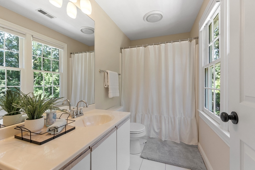 44 Woobly Road Bolton, MA 01740 - Photo 23 of 31 a bathroom with a sink a toilet and a large mirror