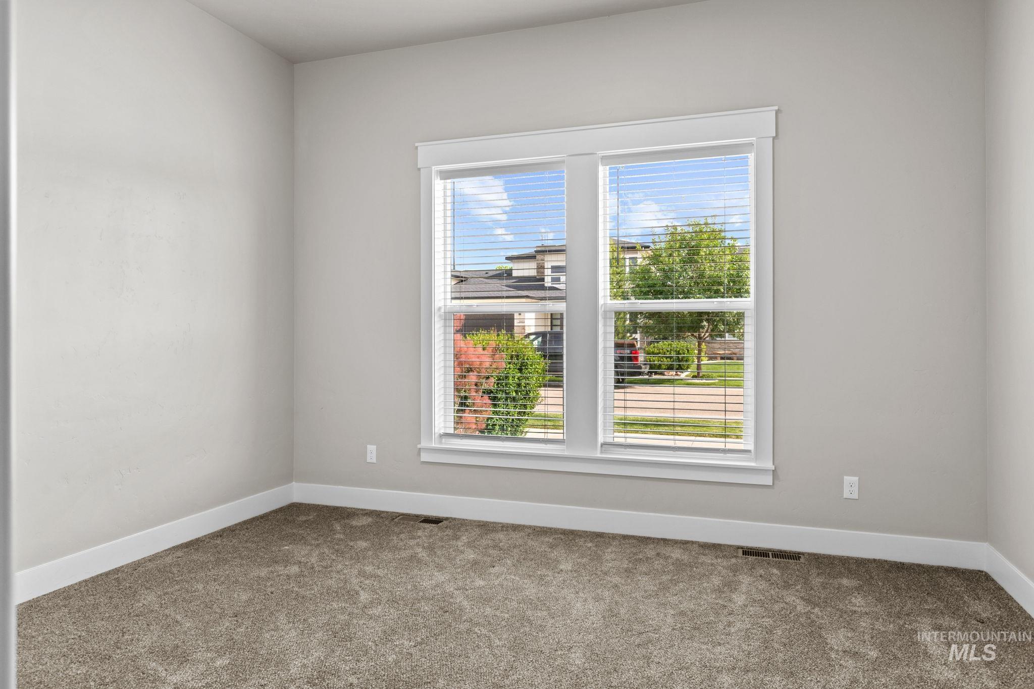 2934 East Murchison Street Meridian, ID 83642 - Photo 28 of 44 Room featuring light gray wall paint, white baseboards, and a large window with white trim and blinds