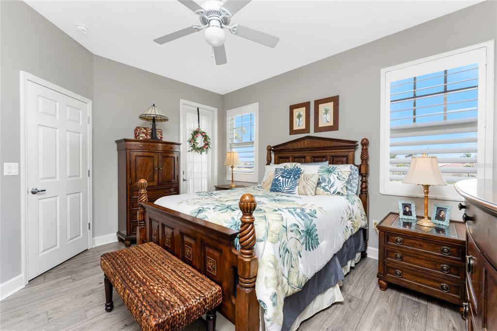 17094 Acapulco Road, Unit 321 Punta Gorda, FL 33955 - Photo 22 of 52 a bedroom with a bed and a chandelier