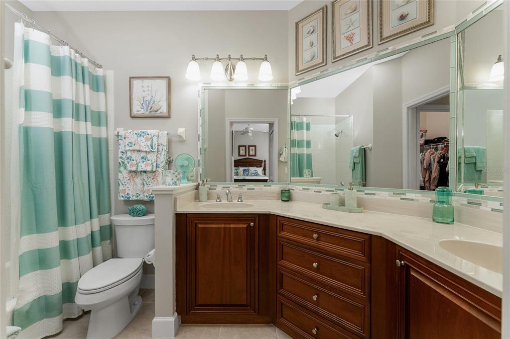 17094 Acapulco Road, Unit 321 Punta Gorda, FL 33955 - Photo 25 of 52 a bathroom with a granite countertop toilet sink and mirror