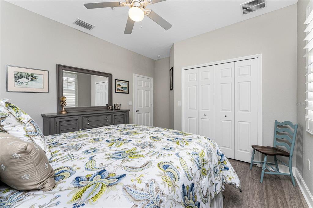 17094 Acapulco Road, Unit 321 Punta Gorda, FL 33955 - Photo 30 of 52 a bedroom with a bed and a chandelier