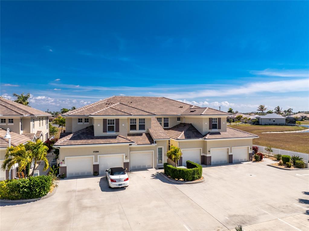 17094 Acapulco Road, Unit 321 Punta Gorda, FL 33955 - Photo 3 of 52 a front view of a house with a yard