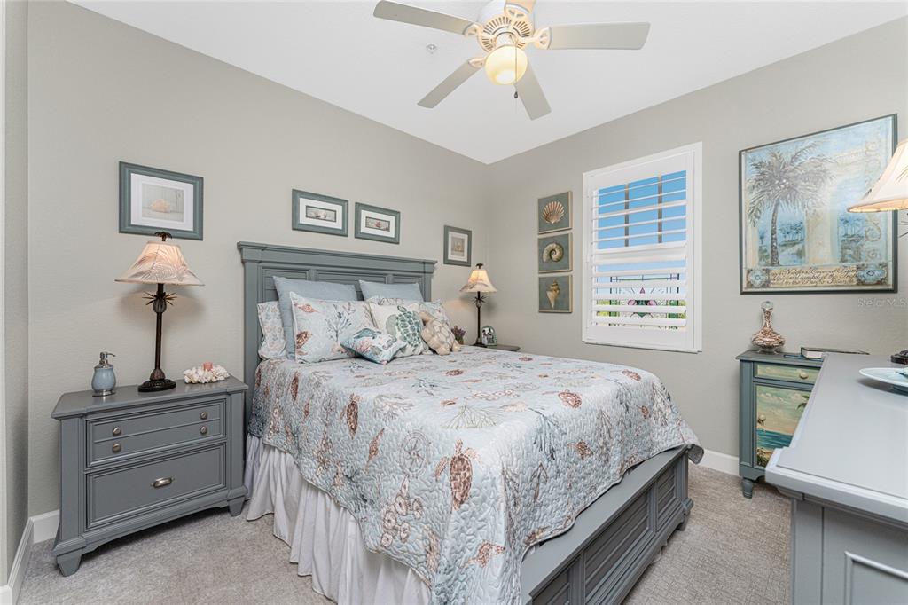 17094 Acapulco Road, Unit 321 Punta Gorda, FL 33955 - Photo 33 of 52 a bedroom with a bed and a chandelier