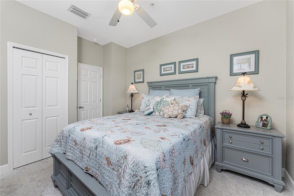 17094 Acapulco Road, Unit 321 Punta Gorda, FL 33955 - Photo 34 of 52 a bedroom with a bed and a chandelier