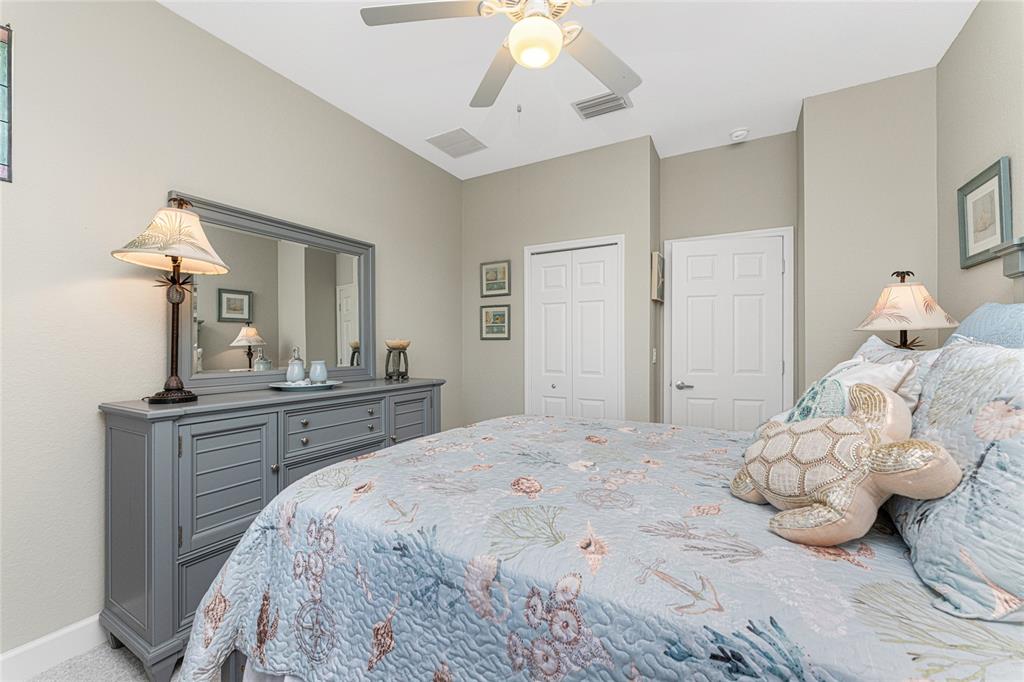 17094 Acapulco Road, Unit 321 Punta Gorda, FL 33955 - Photo 35 of 52 a bedroom with a bed and a chandelier