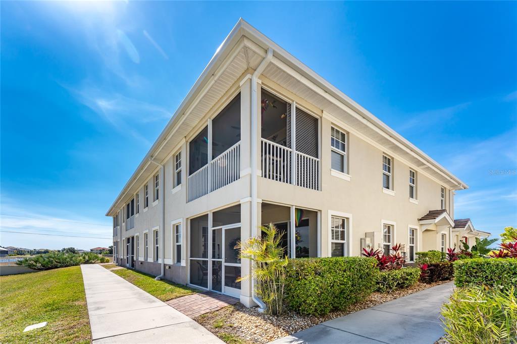 17094 Acapulco Road, Unit 321 Punta Gorda, FL 33955 - Photo 40 of 52 a front view of a house with a yard