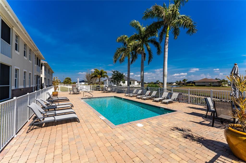 17094 Acapulco Road, Unit 321 Punta Gorda, FL 33955 - Photo 41 of 52 a view of a swimming pool with lounge chair