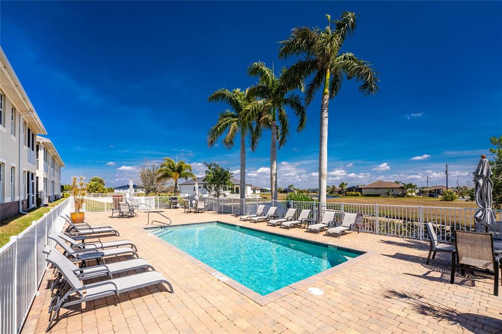 17094 Acapulco Road, Unit 321 Punta Gorda, FL 33955 - Photo 43 of 52 a view of a swimming pool with lounge chairs