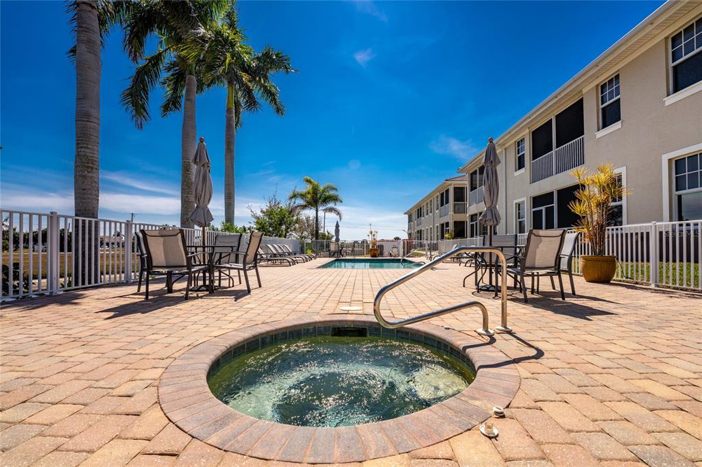 17094 Acapulco Road, Unit 321 Punta Gorda, FL 33955 - Photo 44 of 52 a swimming pool with outdoor seating yard and stairs
