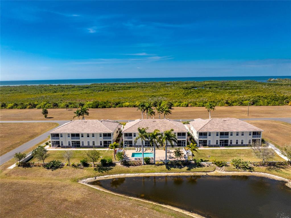 17094 Acapulco Road, Unit 321 Punta Gorda, FL 33955 - Photo 46 of 52 a view of houses with outdoor space and swimming pool