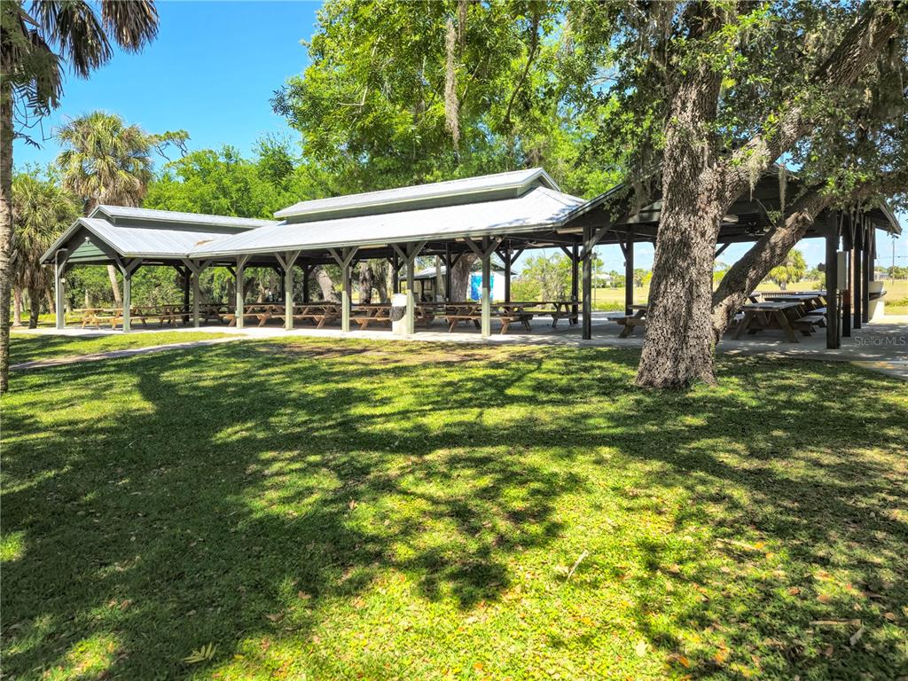 17094 Acapulco Road, Unit 321 Punta Gorda, FL 33955 - Photo 48 of 52 a backyard of a house with table and chairs