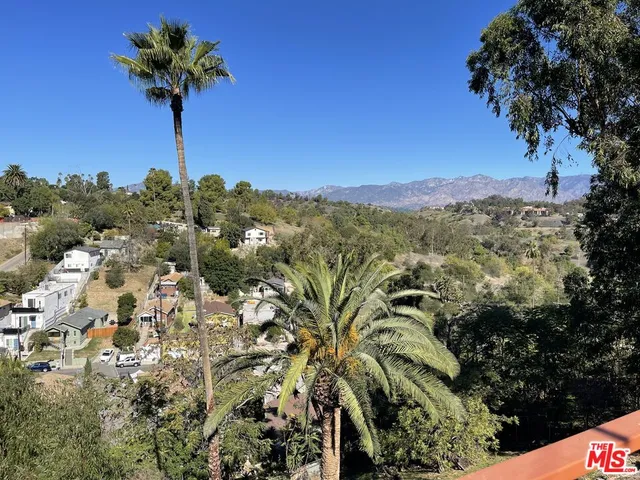 a living room with furniture and painting on the wall