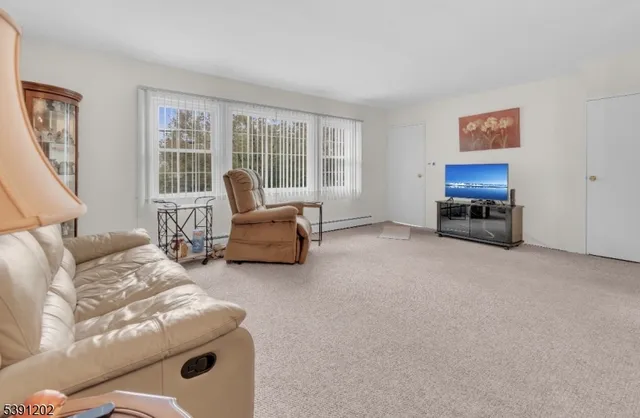 a living room with furniture and a large window
