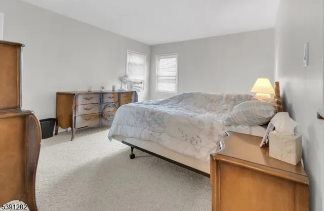 a bedroom with a bed and dresser