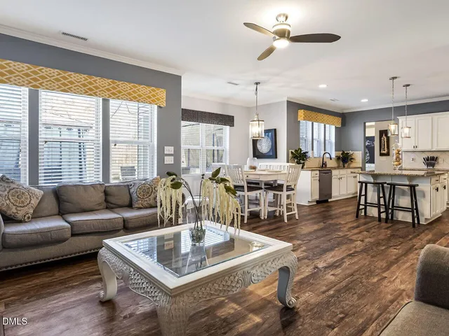 a view of a patio with table and chairs with wooden fence and plants