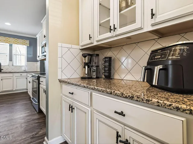 a kitchen with stainless steel appliances granite countertop a sink and cabinets