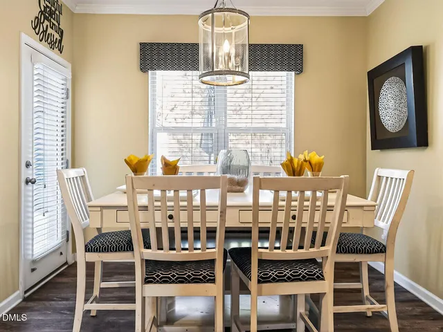 a view of a dining room with furniture and chandelier