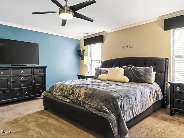 a bedroom with a bed and a tv