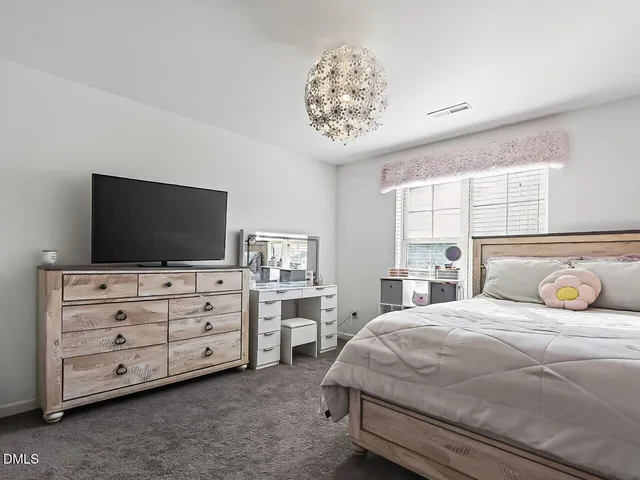 a bedroom with a bed and flat screen tv