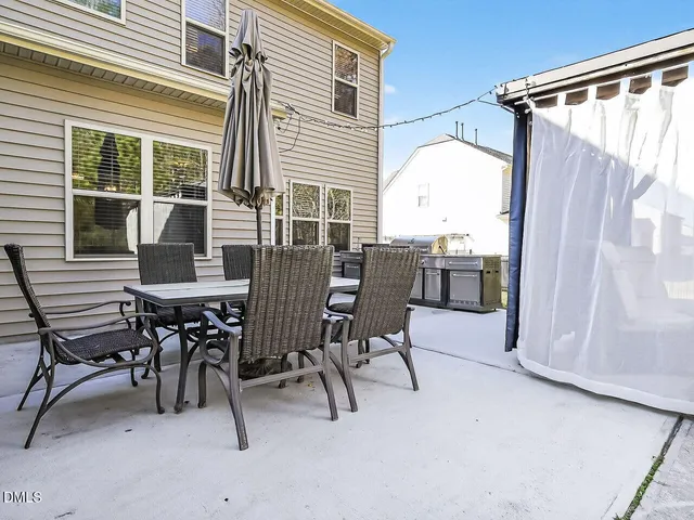 a view of a patio with table and chairs and wooden floor