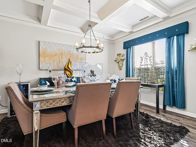 a dining room with furniture a chandelier and window