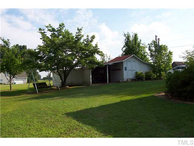 2014 Guy Road Angier, NC 27501 - Photo 8 of 17 Storage barn with shelter on right side of property.