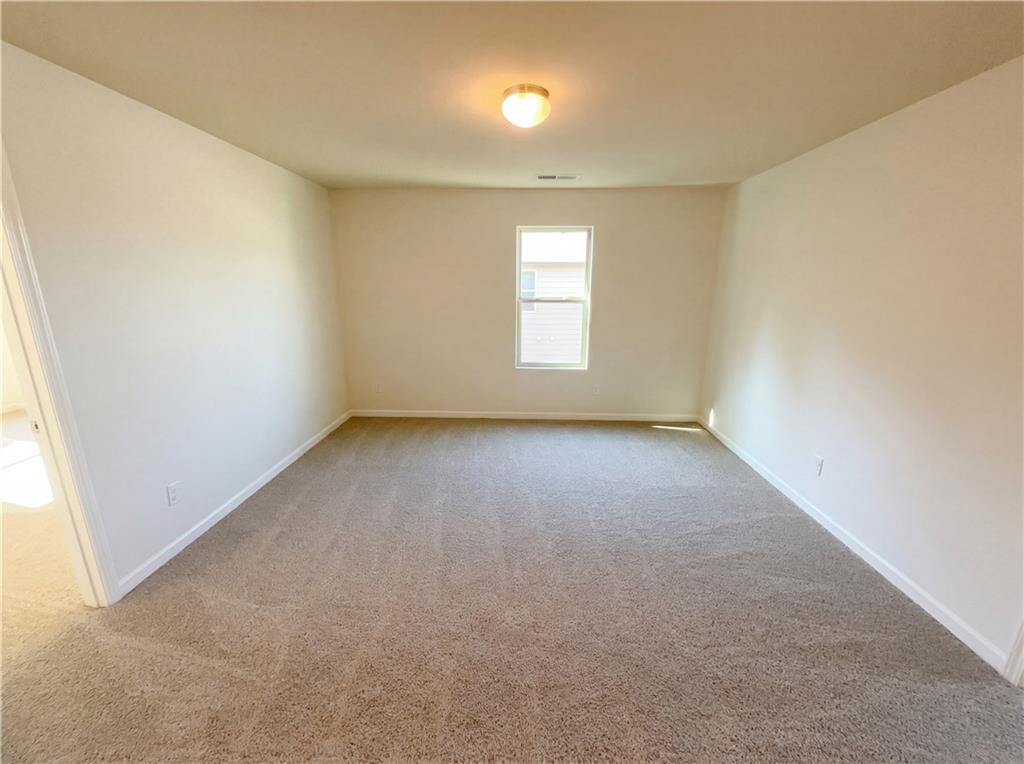 1209 Vienna Court Hampton, GA 30228 - Photo 12 of 21 an empty room with a empty space and windows