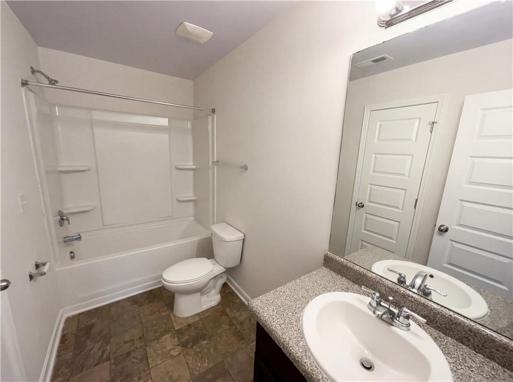 1209 Vienna Court Hampton, GA 30228 - Photo 16 of 21 a bathroom with a sink toilet and shower