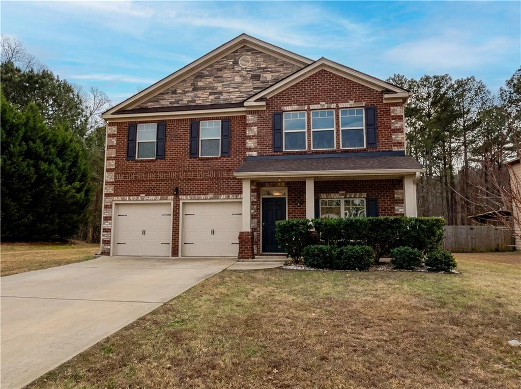 1209 Vienna Court Hampton, GA 30228 - Photo 18 of 21 a front view of a house with a yard