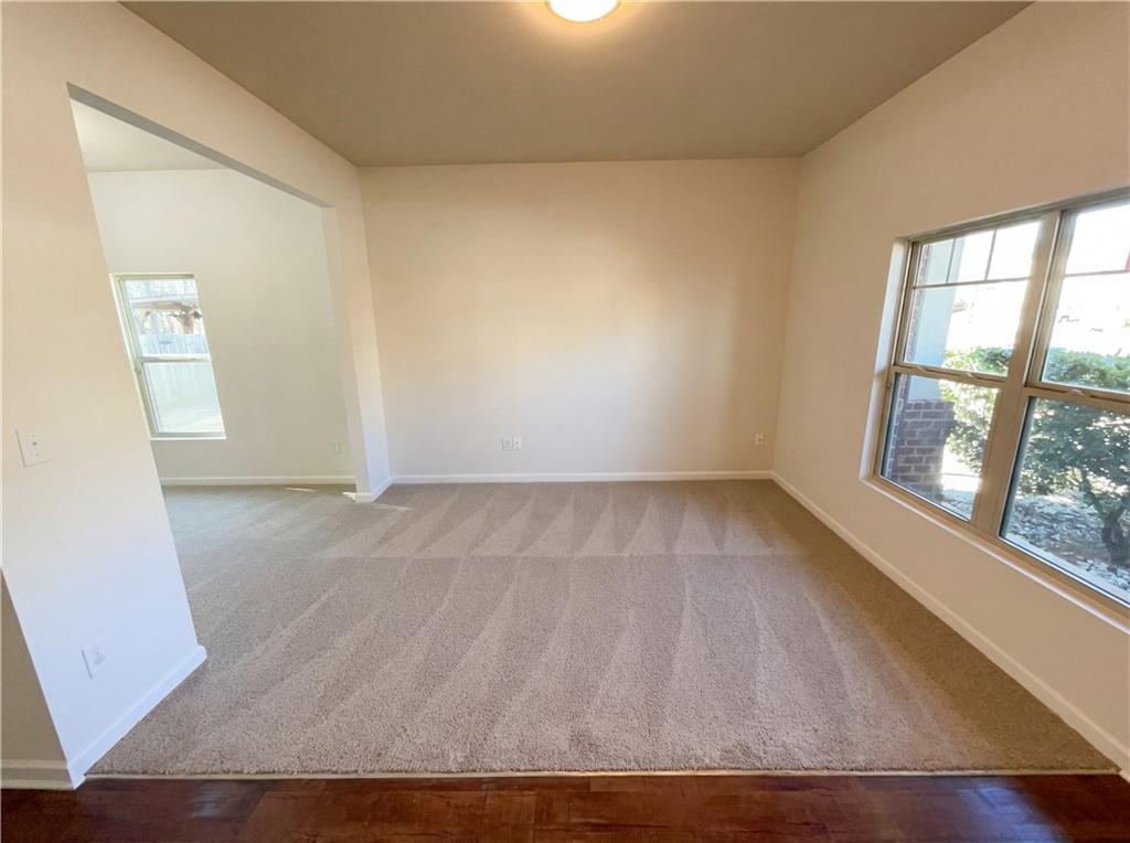 1209 Vienna Court Hampton, GA 30228 - Photo 7 of 21 an empty room with wooden floor and windows