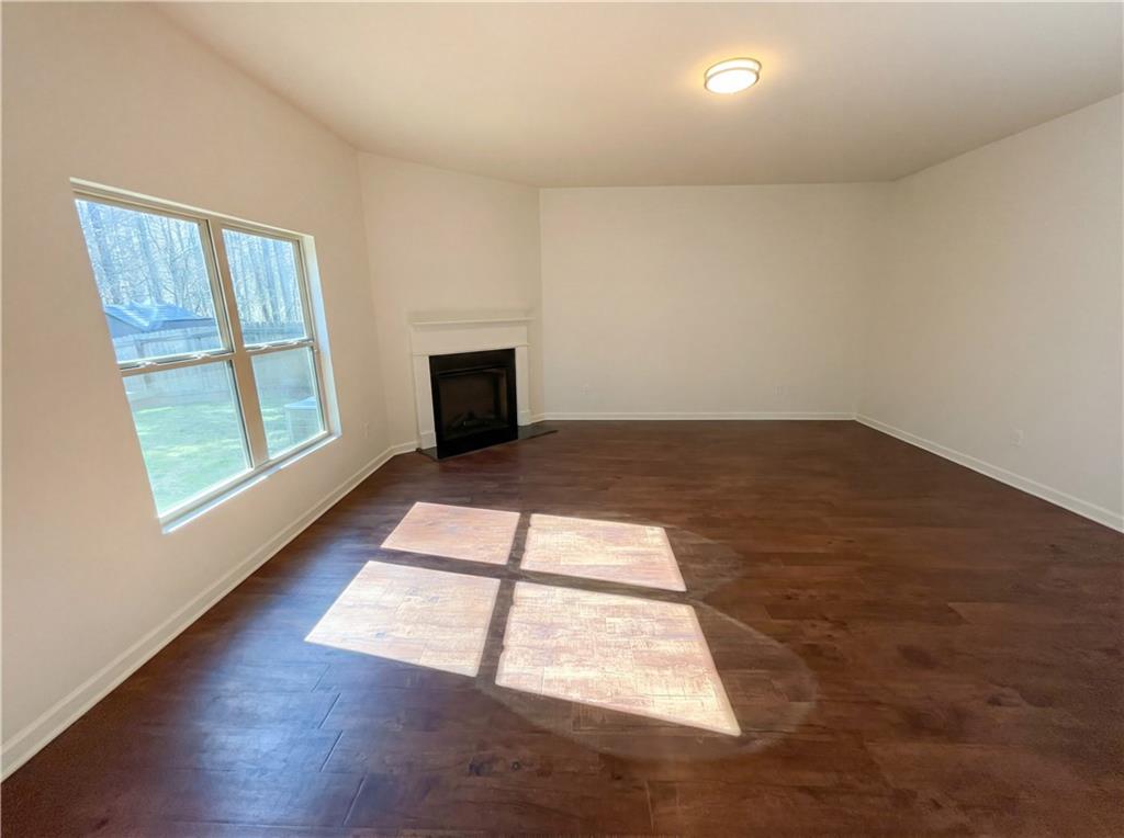 1209 Vienna Court Hampton, GA 30228 - Photo 8 of 21 an empty room with wooden floor and windows